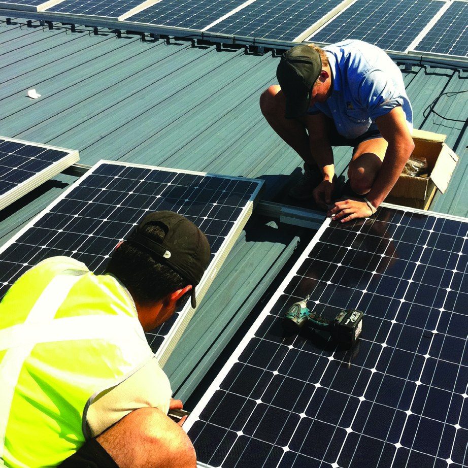 Electrician fitting a solar panel clamp