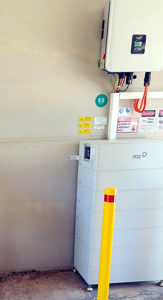 FoxESS home battery and inverter protected by a yellow safety bollard