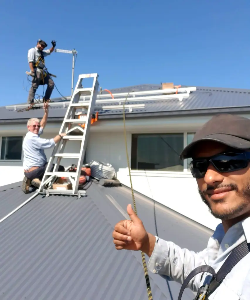 FJ Electrical crew fitting solar mounting rails on a Colorbond roof