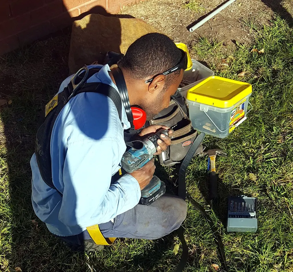 FJ electrician preparing tools and drill bits before an install