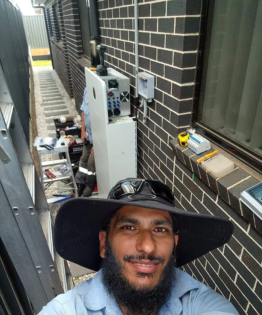 FJ electrician on the job during a home battery install